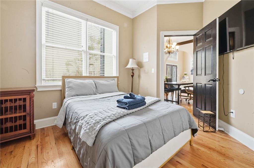 4670 Hamden Forest Drive Southwest Atlanta, GA 30331 - Photo 18 of 68 a bedroom with a bed a dresser and a large window