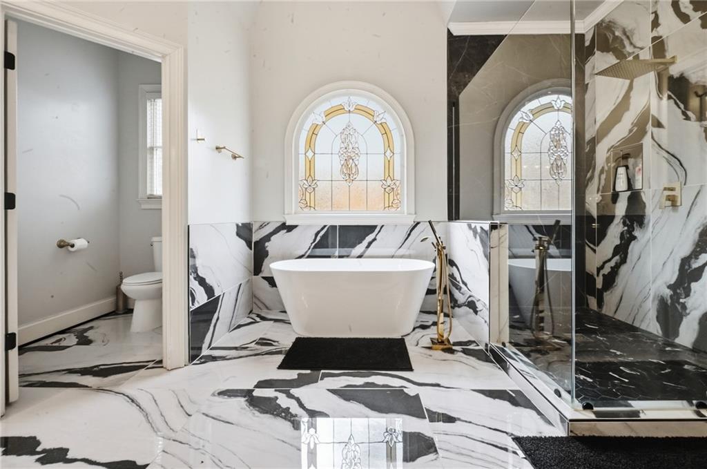 4670 Hamden Forest Drive Southwest Atlanta, GA 30331 - Photo 19 of 68 a white bath tub sitting next to a bathroom sink