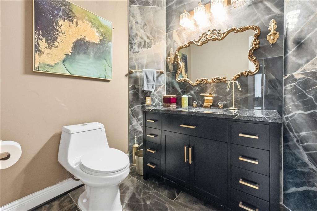 4670 Hamden Forest Drive Southwest Atlanta, GA 30331 - Photo 2 of 68 a bathroom with a toilet sink and vanity
