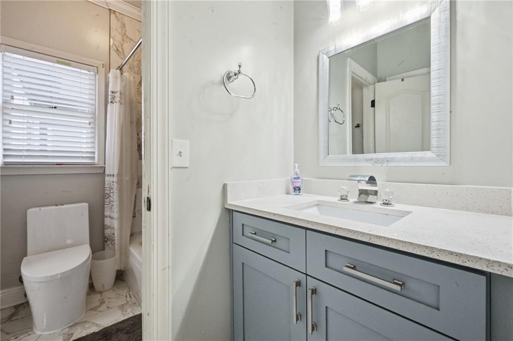 4670 Hamden Forest Drive Southwest Atlanta, GA 30331 - Photo 34 of 68 a bathroom with a toilet sink a mirror and vanity
