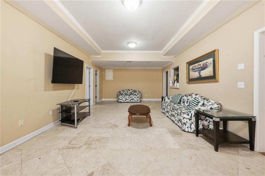 4670 Hamden Forest Drive Southwest Atlanta, GA 30331 - Photo 40 of 68 a living room with furniture and a flat screen tv