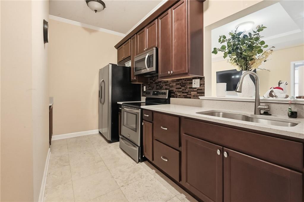 4670 Hamden Forest Drive Southwest Atlanta, GA 30331 - Photo 41 of 68 a kitchen with stainless steel appliances a sink stove and refrigerator
