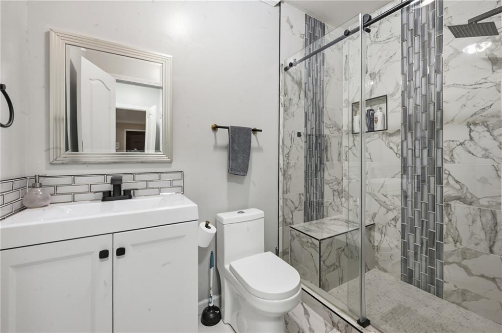 4670 Hamden Forest Drive Southwest Atlanta, GA 30331 - Photo 43 of 68 a bathroom with a toilet sink vanity and mirror