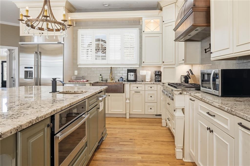 4670 Hamden Forest Drive Southwest Atlanta, GA 30331 - Photo 56 of 68 a kitchen with stainless steel appliances granite countertop a sink stove and cabinets