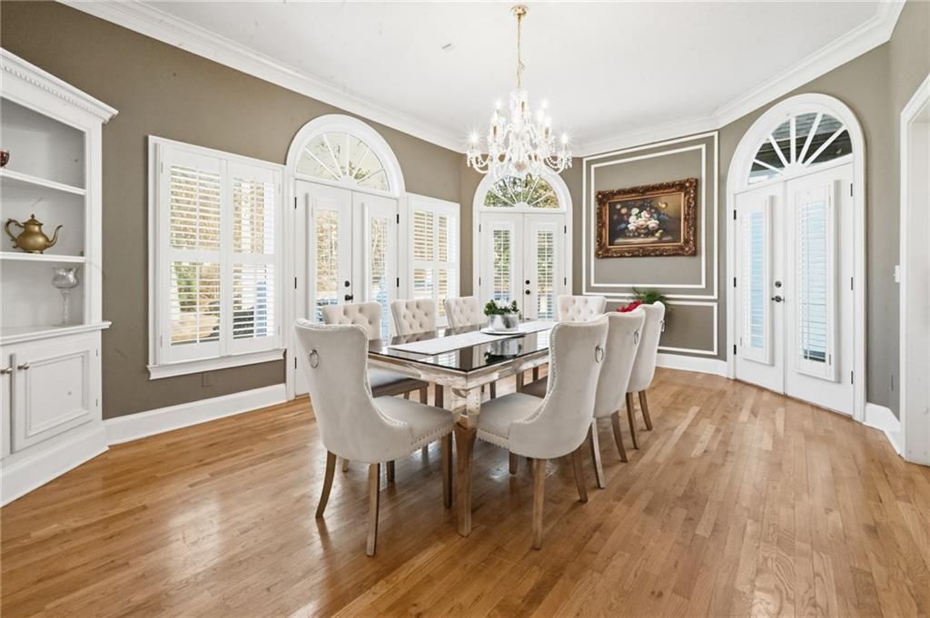 4670 Hamden Forest Drive Southwest Atlanta, GA 30331 - Photo 10 of 68 a view of a dining room with furniture a chandelier and wooden floor
