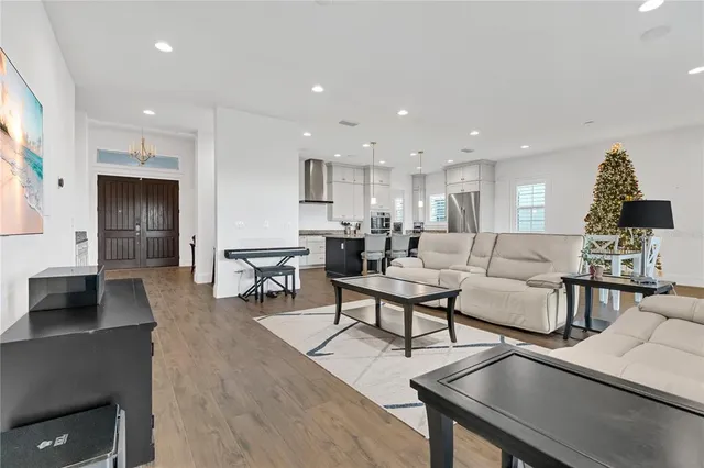 a kitchen with granite countertop white cabinets and a wooden floor