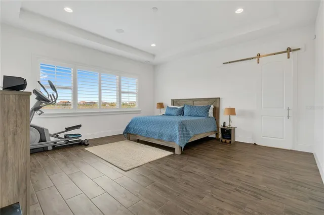 an aerial view of residential houses with outdoor space and ocean view