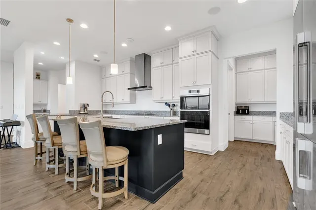 a spacious bathroom with a bathtub sink mirror and