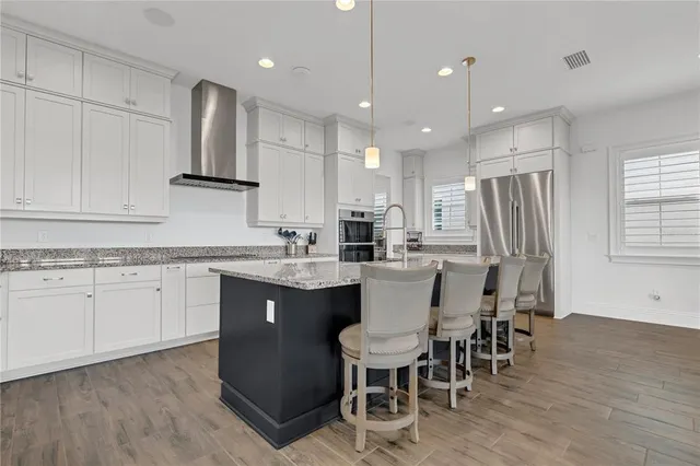 a spacious bathroom with a tub sink and mirror
