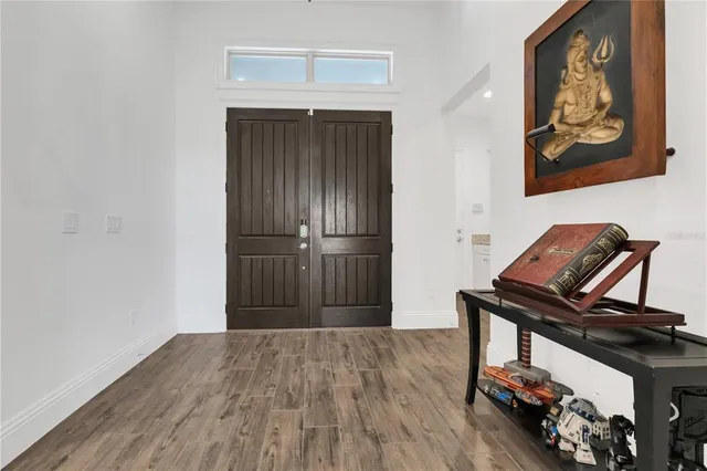 a bathroom with a granite countertop sink a mirror and a bathtub