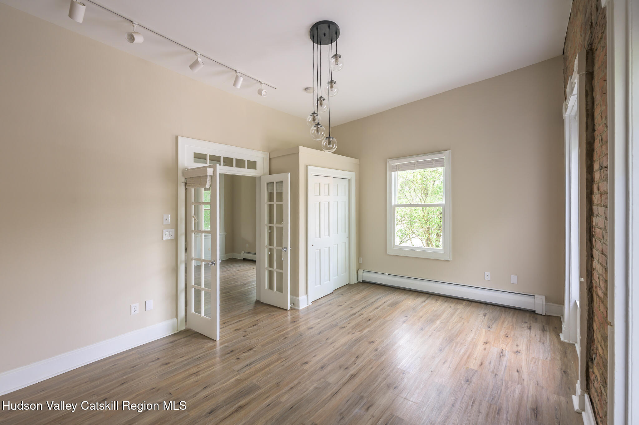 237 Warren Street Hudson, NY 12534 - Photo 22 of 39 a view of empty room with wooden floor and fan