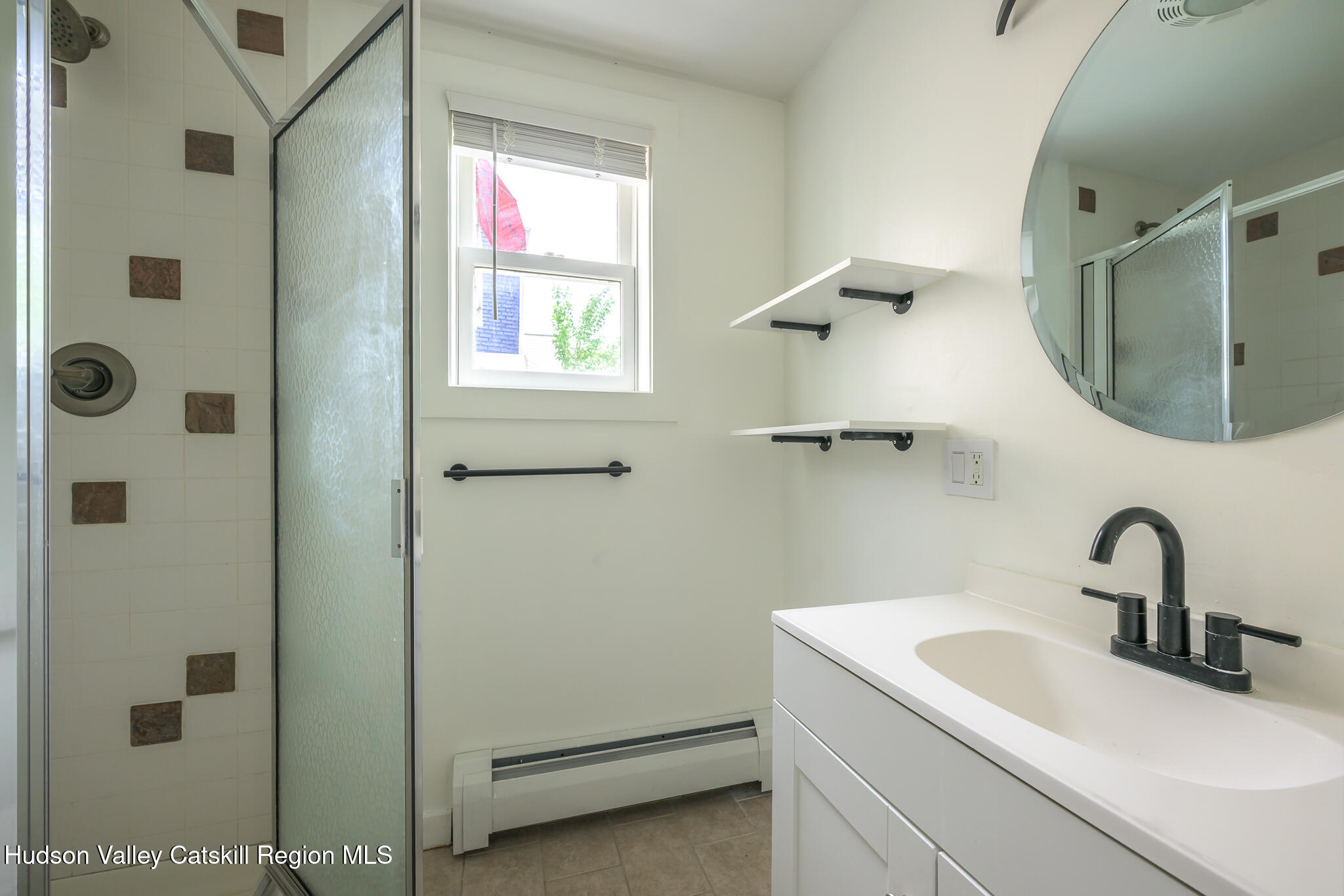 237 Warren Street Hudson, NY 12534 - Photo 27 of 39 a bathroom with a sink and mirror