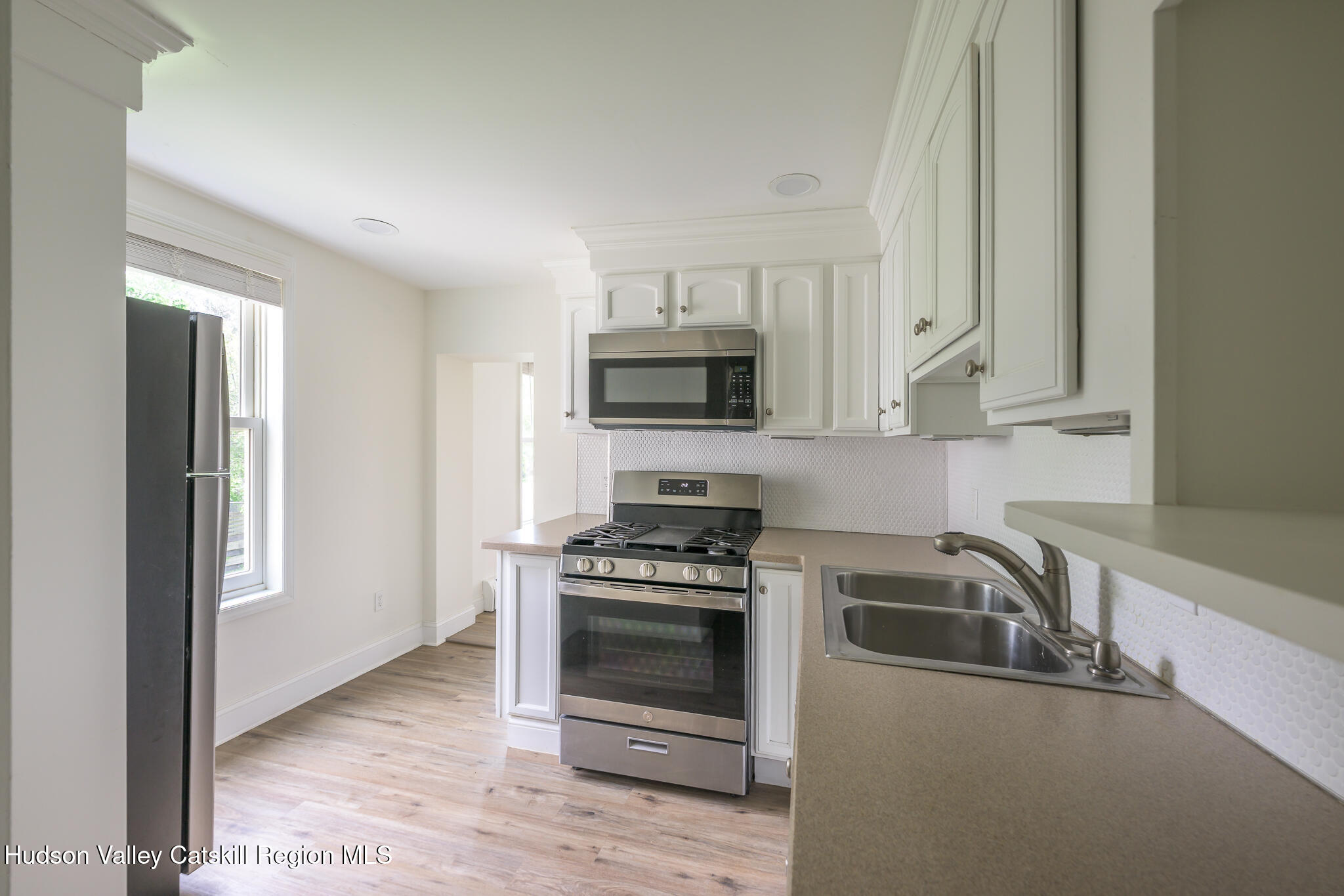 237 Warren Street Hudson, NY 12534 - Photo 28 of 39 a kitchen with granite countertop a stove and a sink