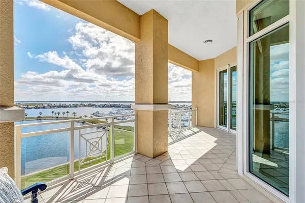 a view of a balcony with floor to ceiling windows with wooden floor