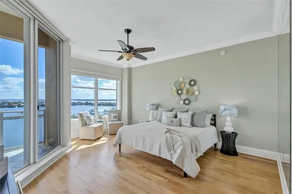 a bedroom with a large bed and a chandelier