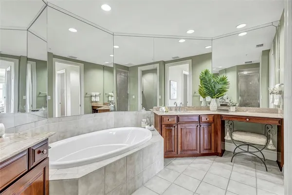 a spacious bathroom with a granite countertop tub sink and mirror