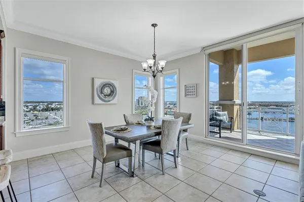 a dining room with furniture a chandelier and window