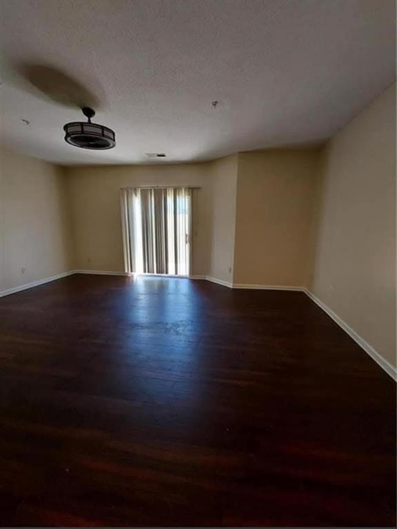 1749 Broad River Road Atlanta, GA 30349 - Photo 6 of 10 a view of an empty room with wooden floor and a window