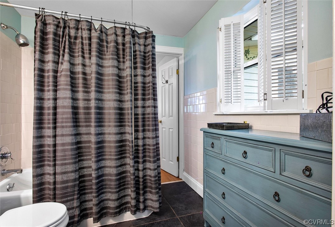 9606 Meadowview Road Henrico, VA 23294 - Photo 14 of 27 a bathroom with a sink a toilet and shower curtain