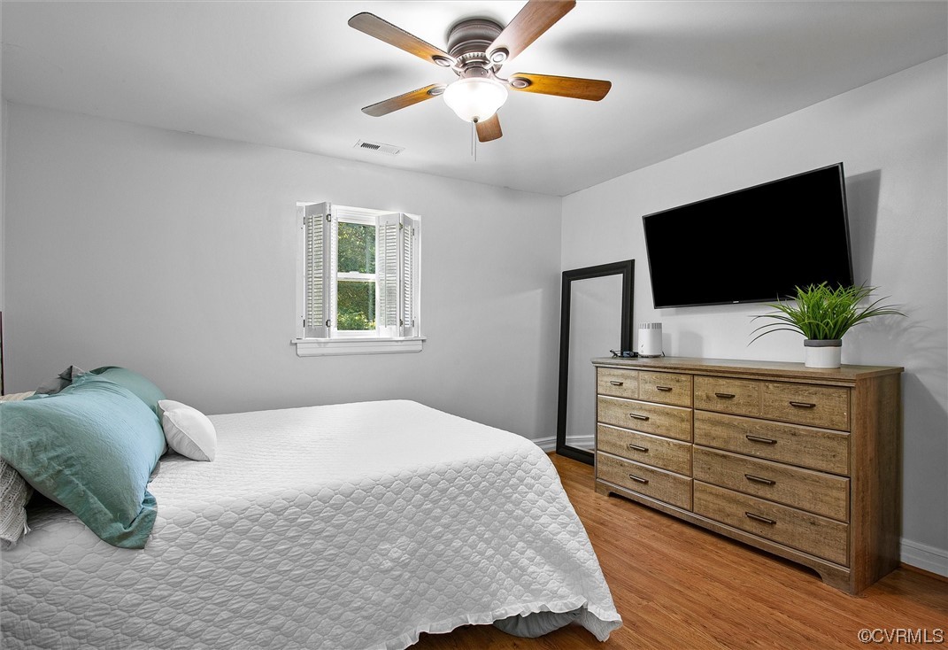 9606 Meadowview Road Henrico, VA 23294 - Photo 15 of 27 a bedroom with a bed a window and a flat screen television
