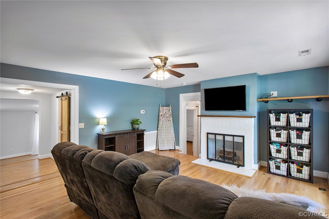 9606 Meadowview Road Henrico, VA 23294 - Photo 16 of 27 a living room with furniture a fireplace and a flat screen tv