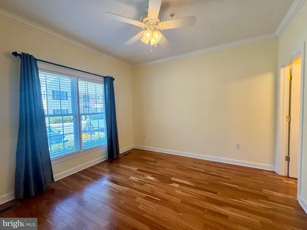 a view of a room with wooden floor