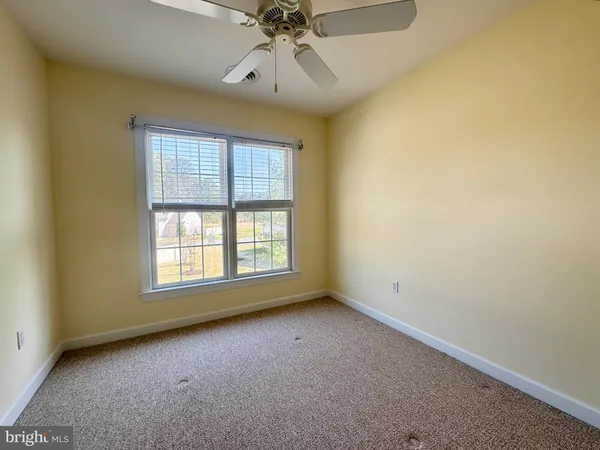a bathroom with a sink a toilet and a large mirror