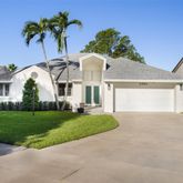 a view of a house with a yard and potted plants