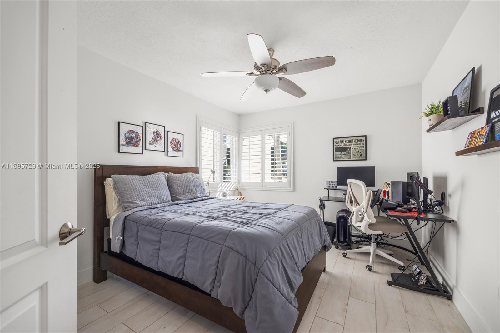 21960 Southwest 98th Avenue Cutler Bay, FL 33190 - Photo 13 of 25 a bedroom with a bed a flat screen tv and a window