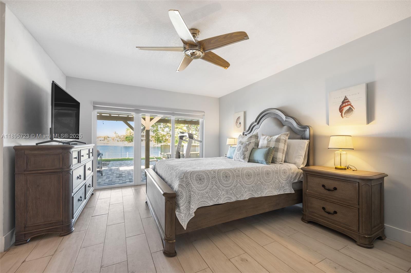 21960 Southwest 98th Avenue Cutler Bay, FL 33190 - Photo 15 of 25 a bedroom with a bed and a flat screen tv