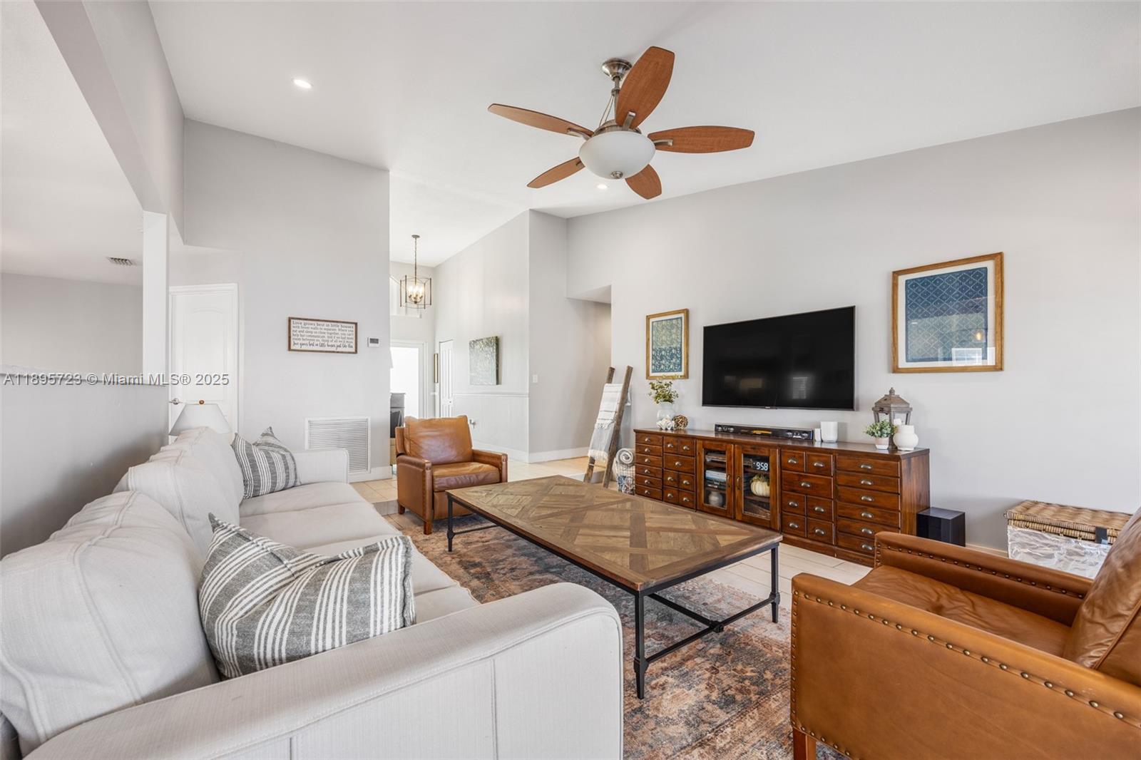 21960 Southwest 98th Avenue Cutler Bay, FL 33190 - Photo 5 of 25 a living room with furniture and a flat screen tv