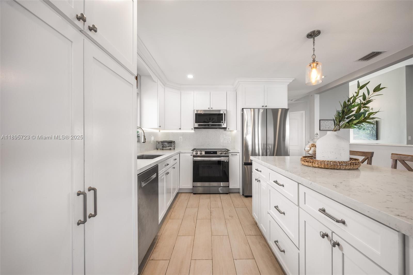 21960 Southwest 98th Avenue Cutler Bay, FL 33190 - Photo 7 of 25 a large kitchen with a stove top oven and refrigerator