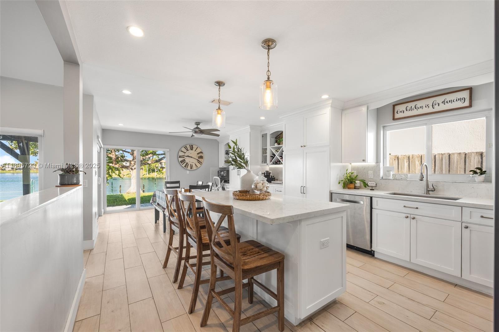 21960 Southwest 98th Avenue Cutler Bay, FL 33190 - Photo 9 of 25 a view of a kitchen and dining table chairs