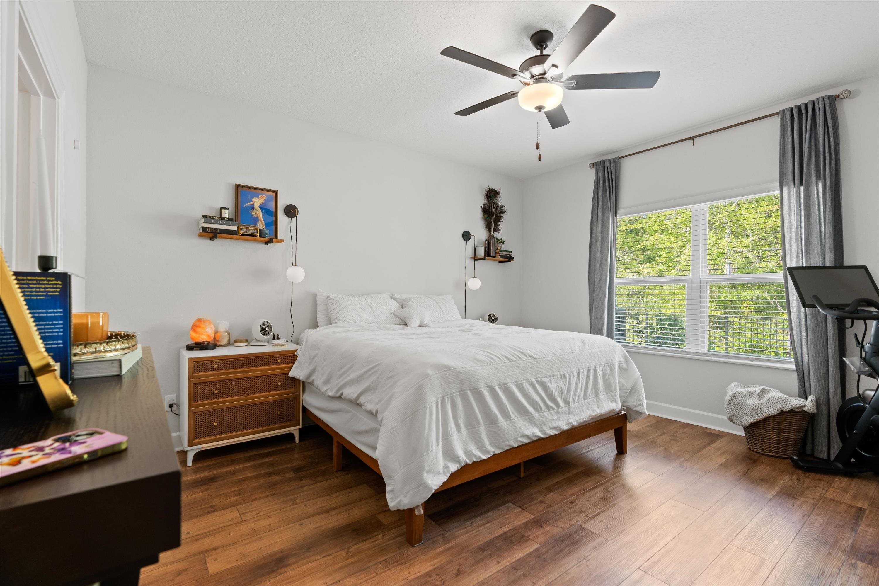 793 Morgans Treasure Road St. Augustine, FL 32084 - Photo 16 of 24 a bedroom with a bed a large window and wooden floor
