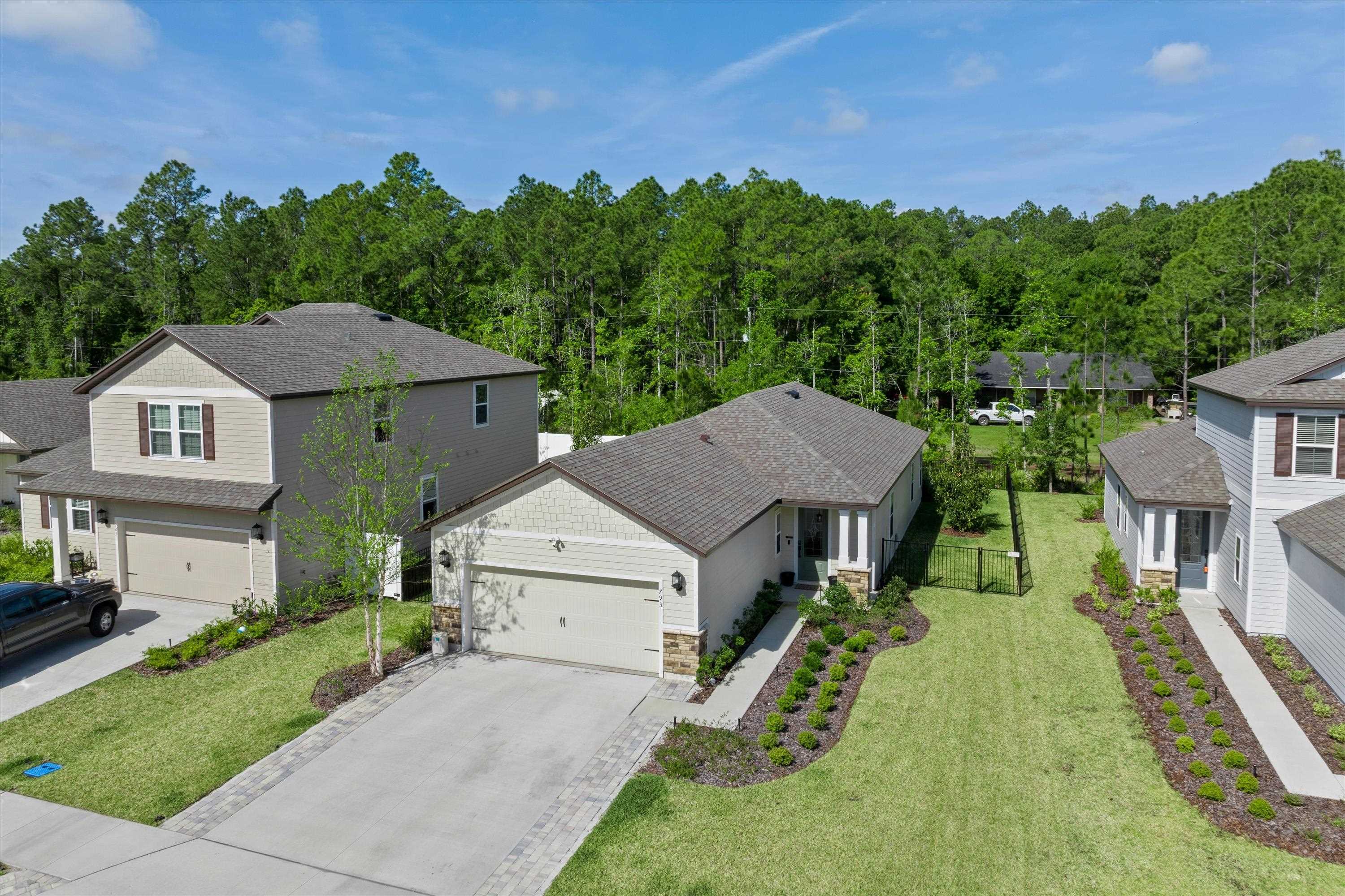 793 Morgans Treasure Road St. Augustine, FL 32084 - Photo 2 of 24 a aerial view of a house next to a yard