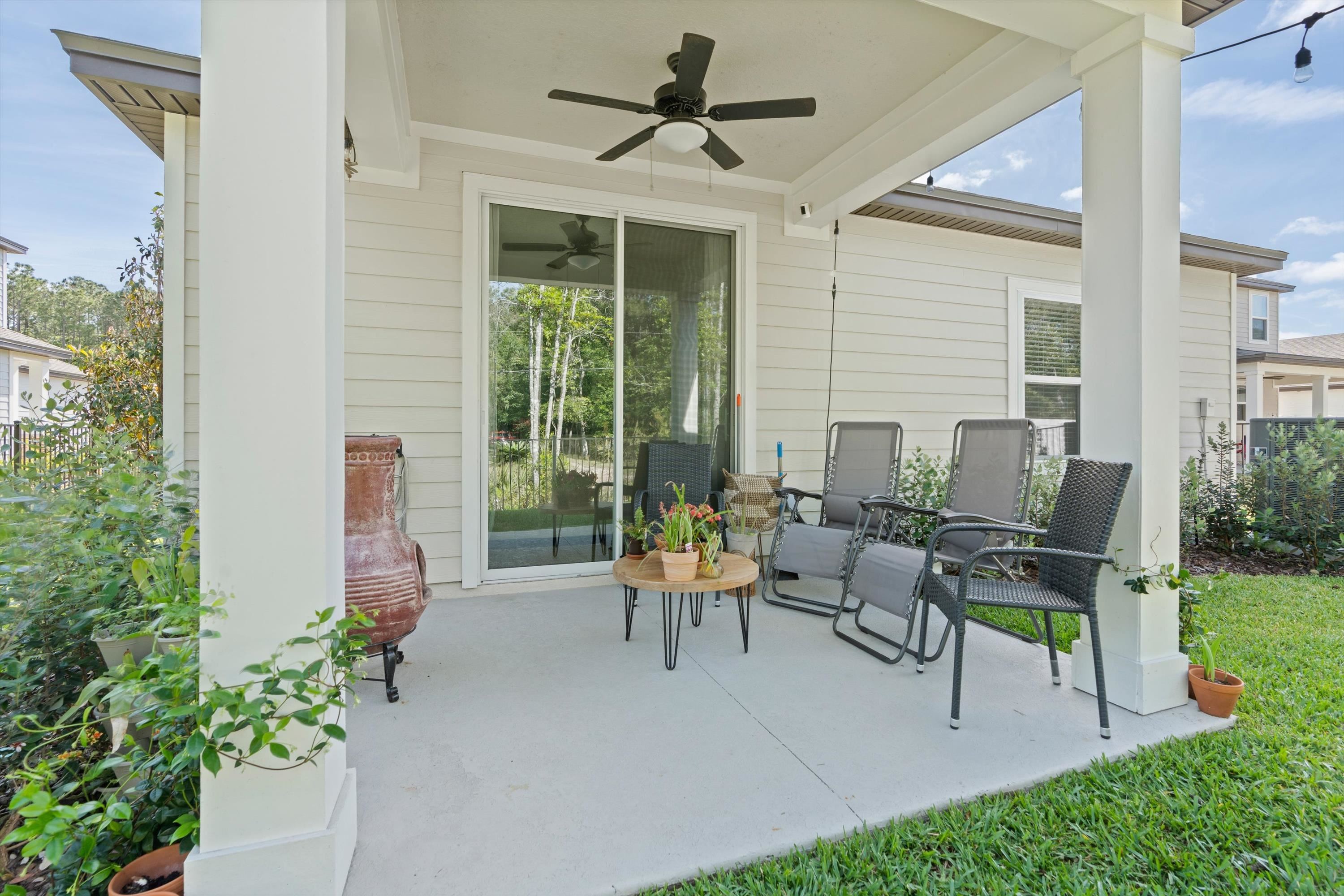793 Morgans Treasure Road St. Augustine, FL 32084 - Photo 21 of 24 a living room with patio furniture and a garden