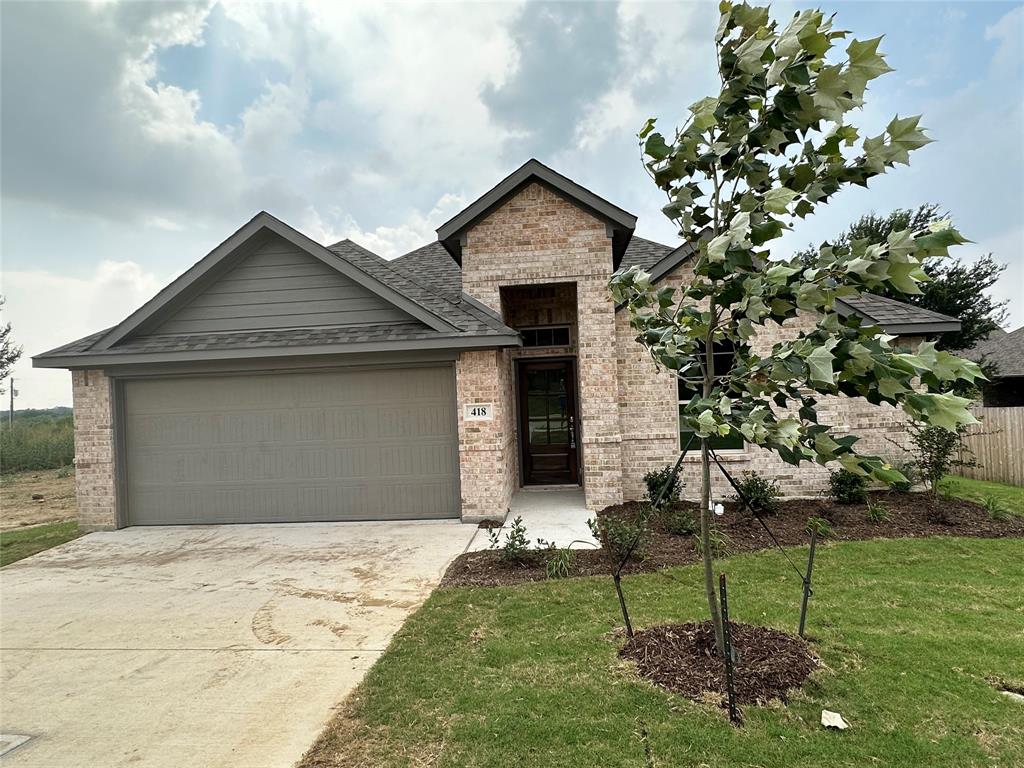 418 South 2nd Street Krum, TX 76249 - Photo 1 of 17 a house with garden in front of it
