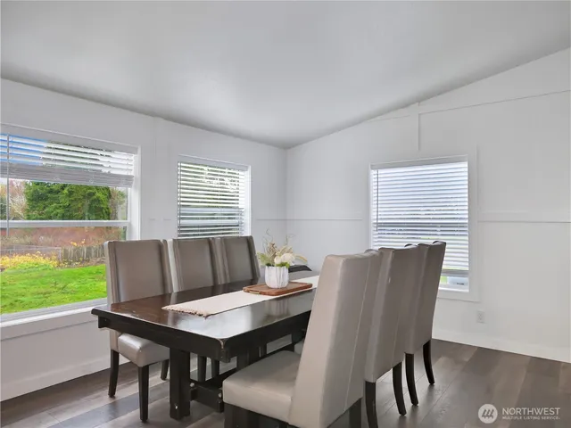 an outdoor sitting area with furniture and lake view