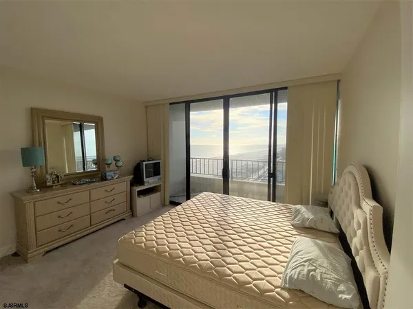 a bedroom with a large bed and a large window