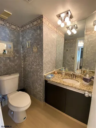 a bathroom with a sink toilet and a mirror