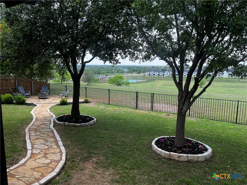 720 Copper Ridge Loop Temple, TX 76502 - Photo 1 of 1 a swimming pool with some trees in the background