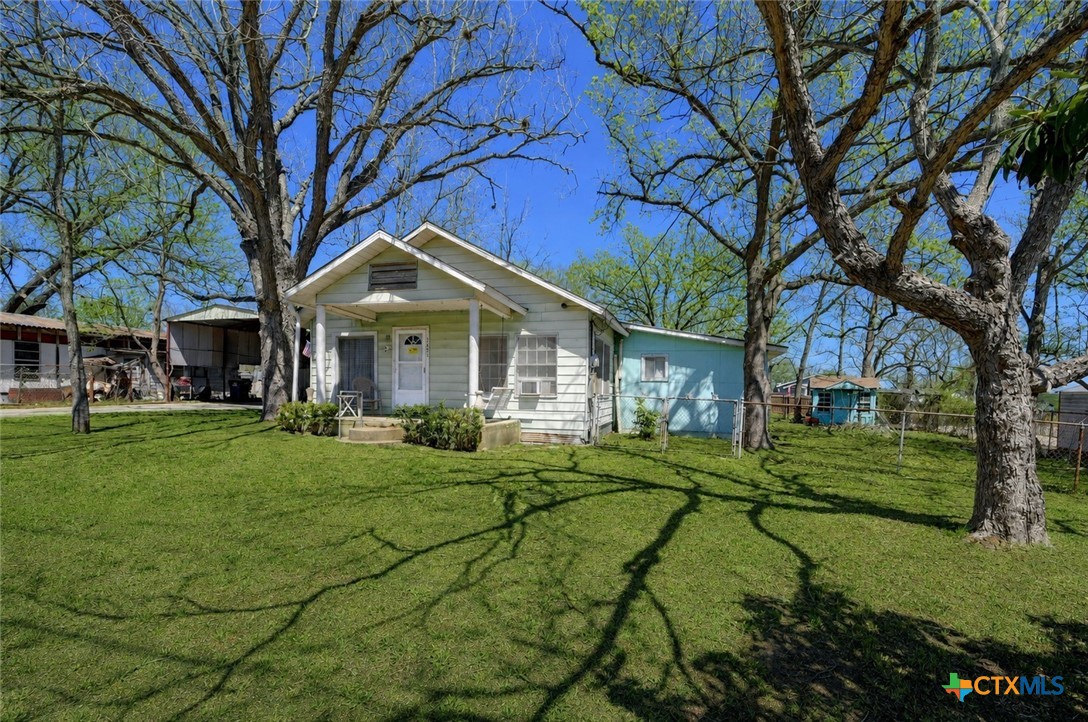 1631 East Fannin Street Luling, TX 78648 - Photo 1 of 27 a front view of a house with a yard