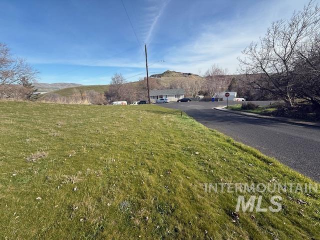 0 Silcott Street Lewiston, ID 83501 - Photo 7 of 9 View of asphalt road with a mountain view and traffic signs