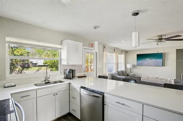 a kitchen with refrigerator cabinets and wooden floor