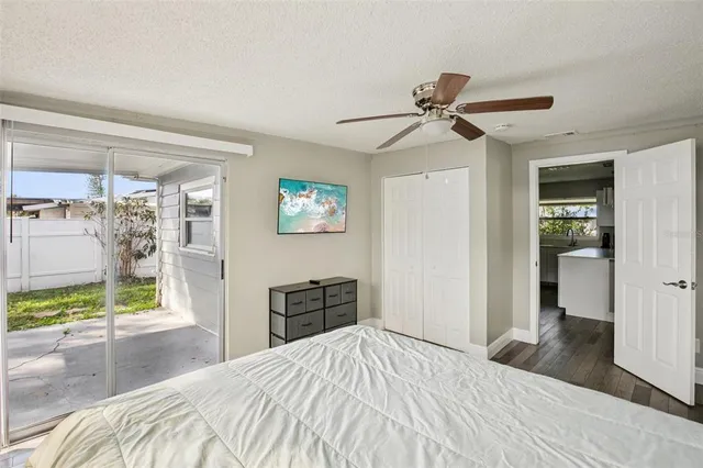 a bed sitting in a bedroom next to a window