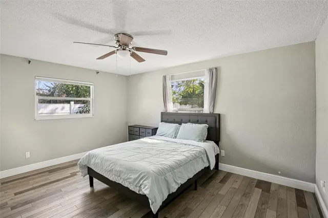 a bedroom with bed and wooden floor