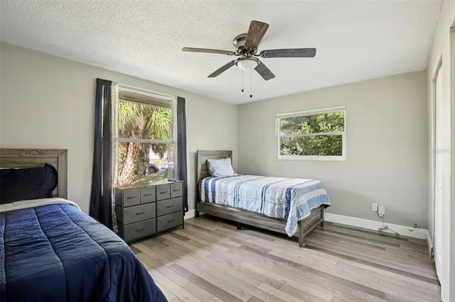 a bedroom with a large bed and a large window