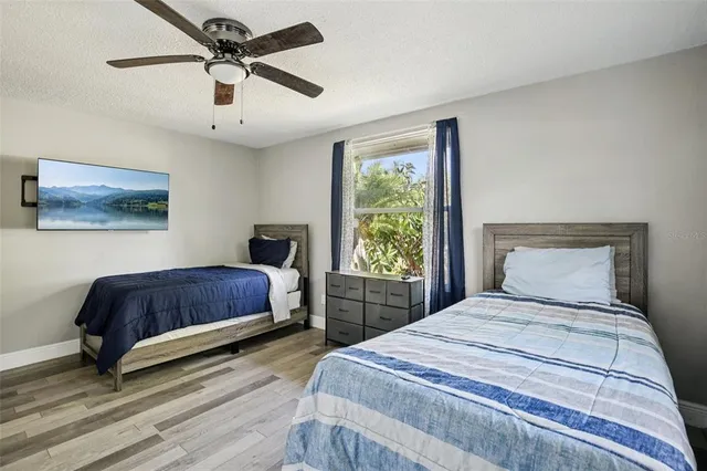 a bedroom with a bed and a painting on the wall