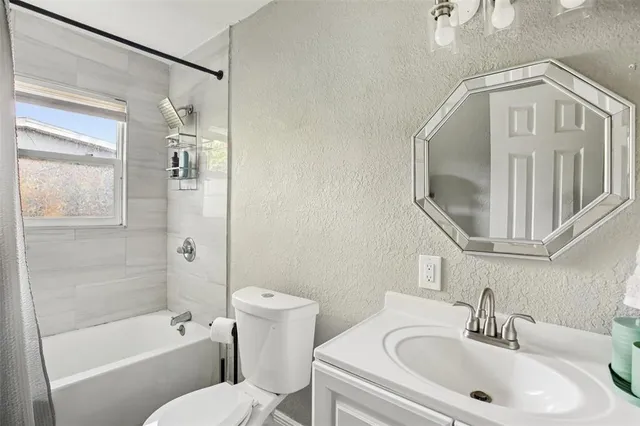 a en suite bathroom with a sink a toilet and a mirror