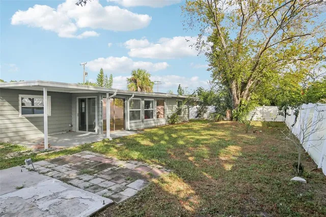 a view of a house with a backyard